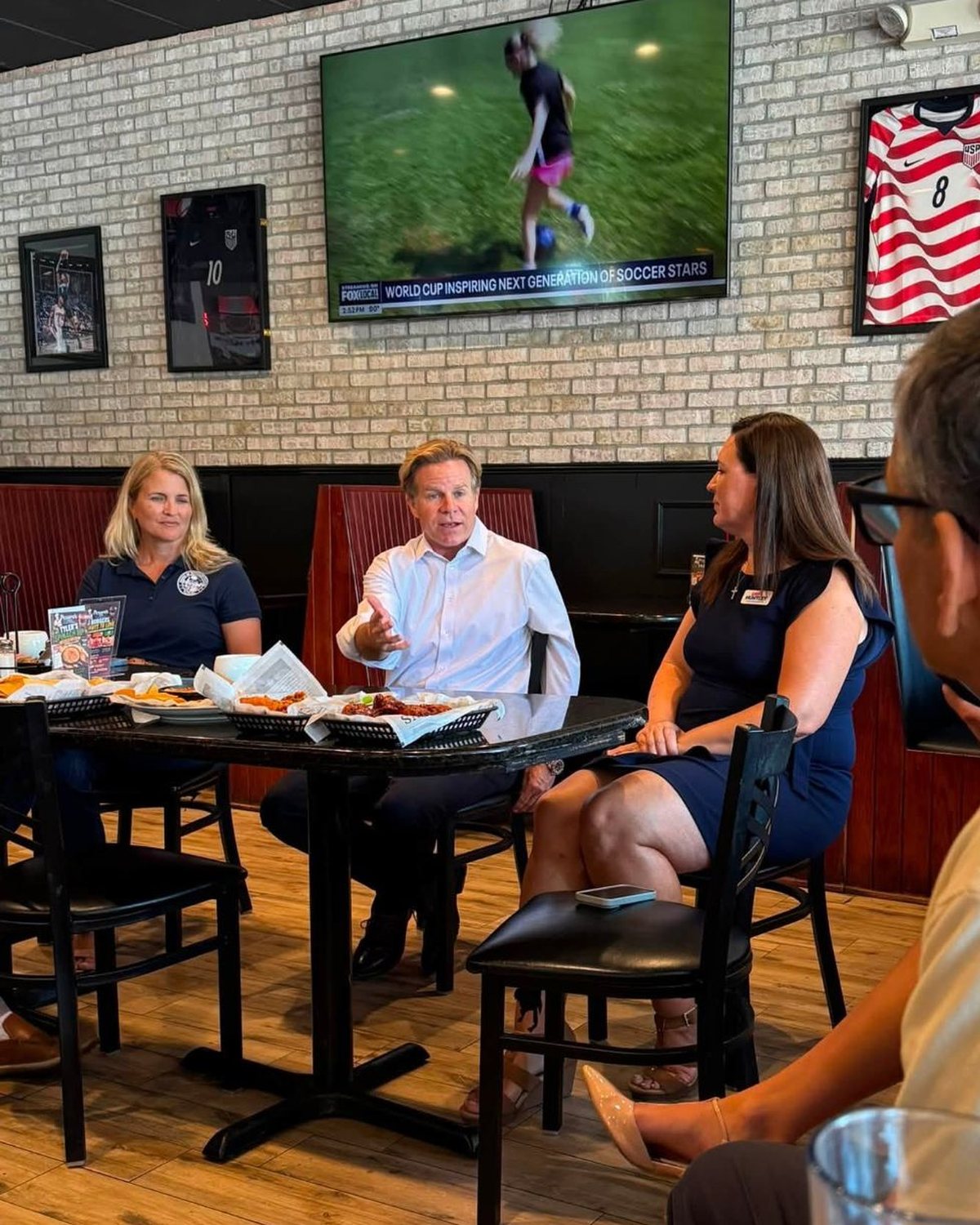 Mike Haridopolos talking with working people at a Space Coast restaurant