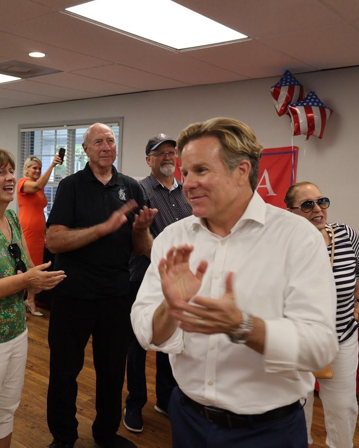 Mike Haridopolos applauding alongside Space Coast seniors at a community event